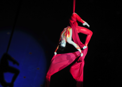 Jen in flame costume on red silks